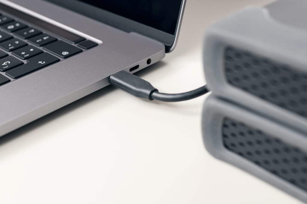 Detail of External hard disk cable connected to a modern laptop